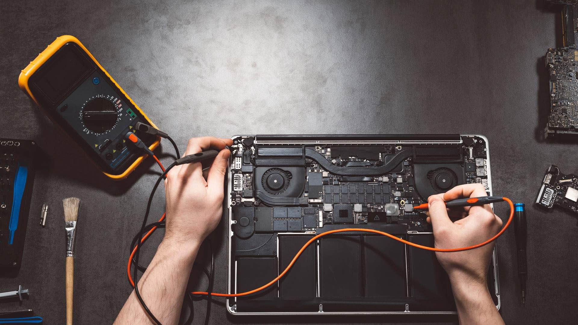 IT technician supporting a customer with computer repair in Kingsbridge